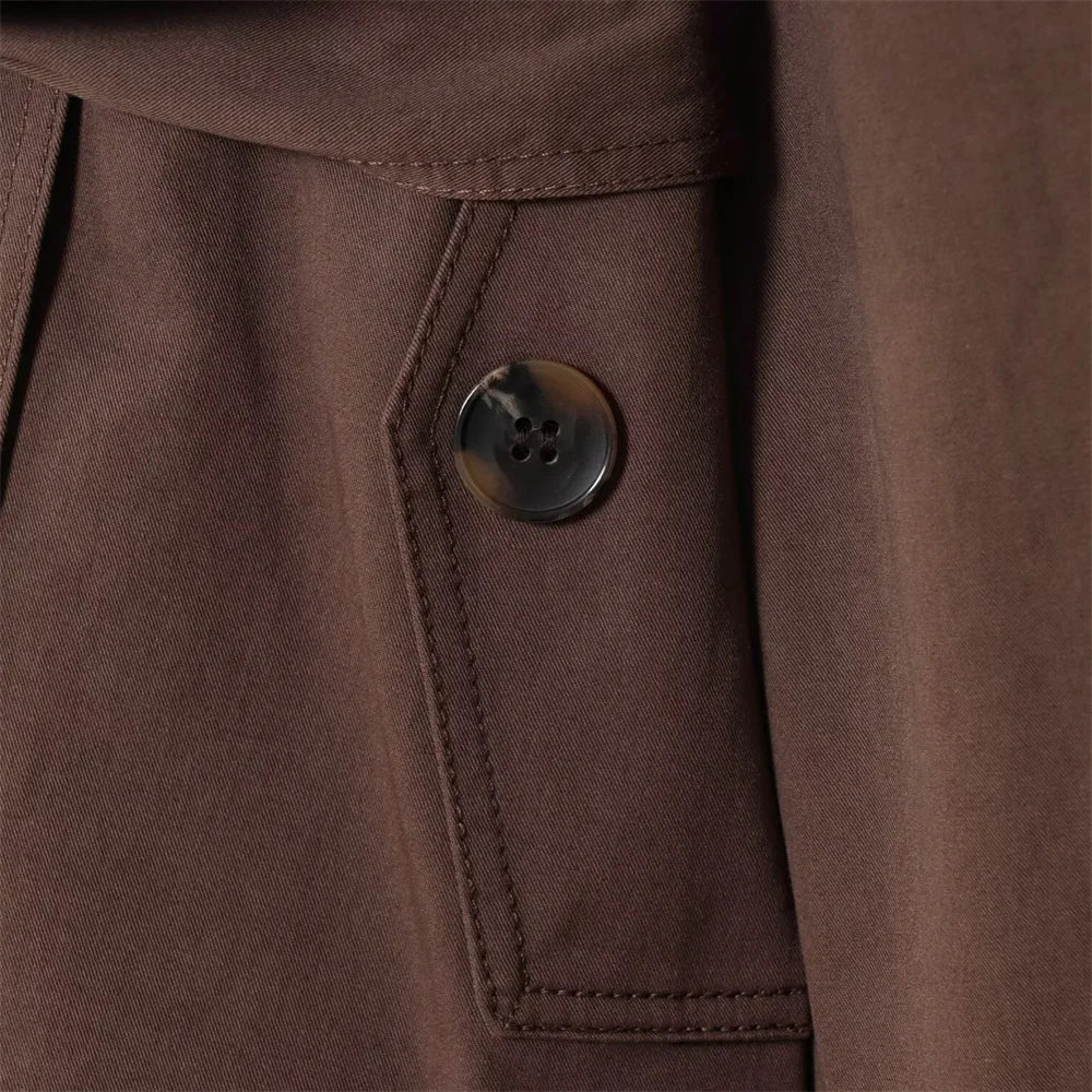 new women's clothing design features a loose and versatile short trench coat with a lapel and waist belt