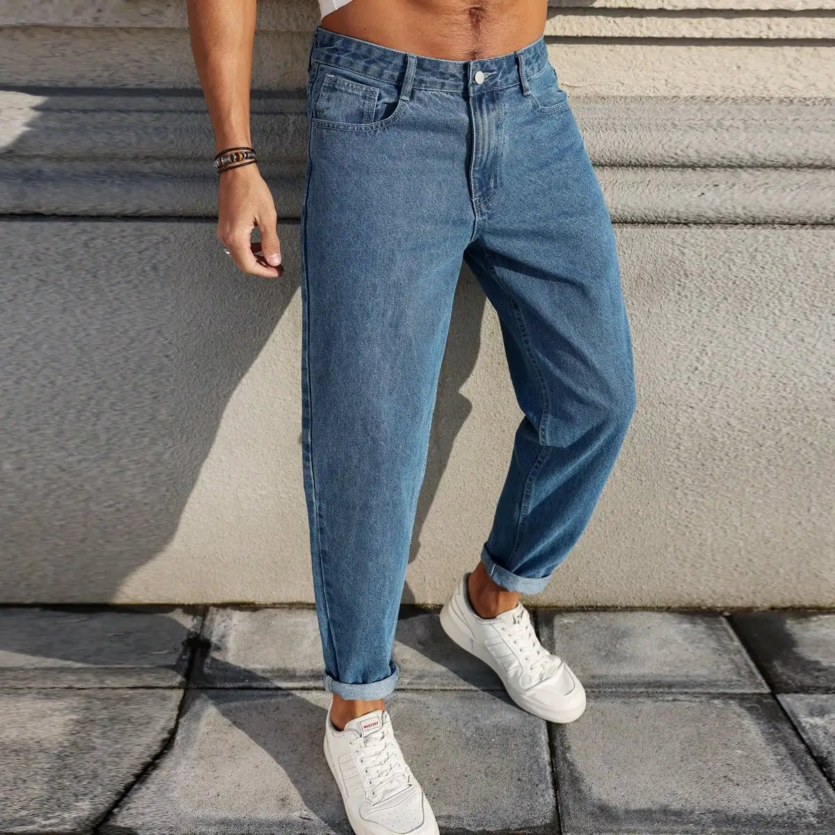 Men's jeans are made of classic blue denim fabric with a loose fit, making them an indispensable versatile item in the wardrobe.