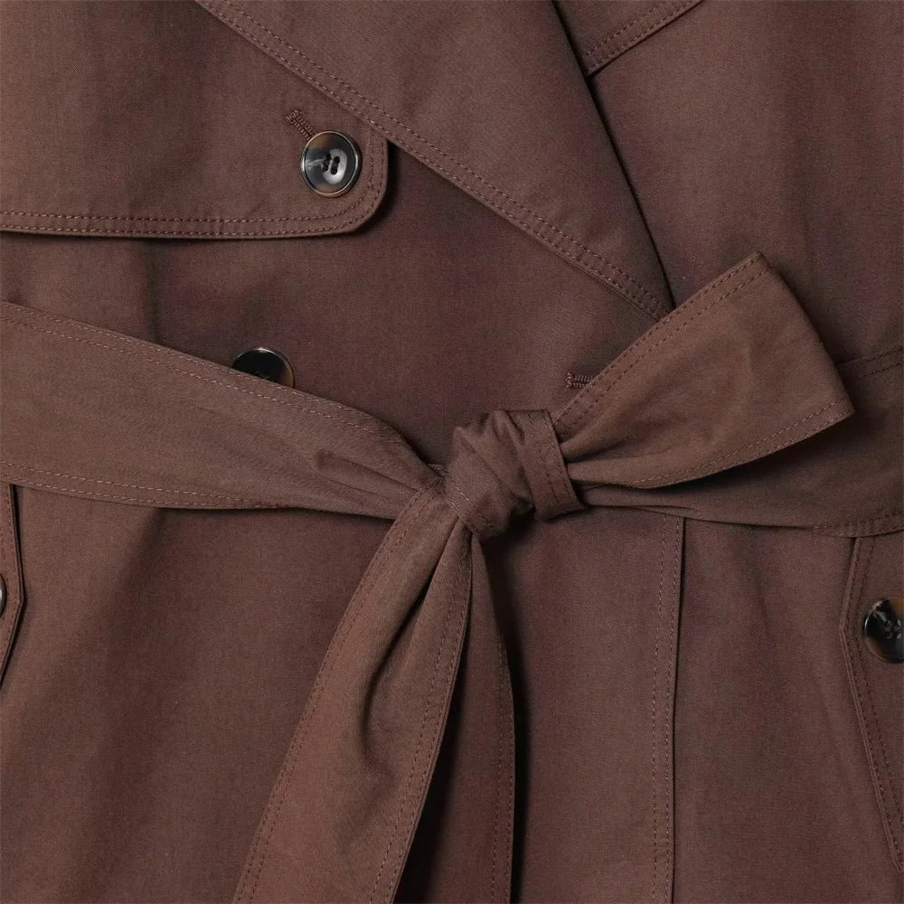 new women's clothing design features a loose and versatile short trench coat with a lapel and waist belt