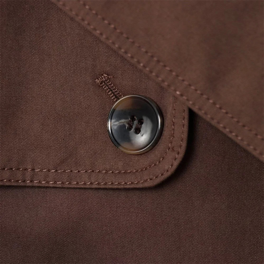 new women's clothing design features a loose and versatile short trench coat with a lapel and waist belt