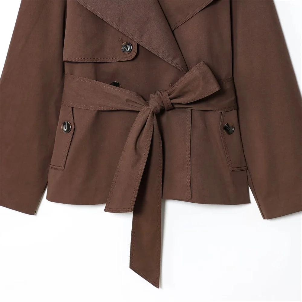 new women's clothing design features a loose and versatile short trench coat with a lapel and waist belt